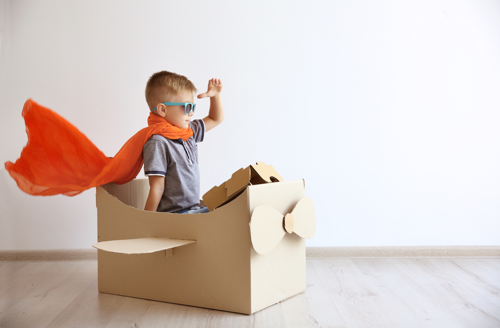 Boy Playing with Carboard Airplane