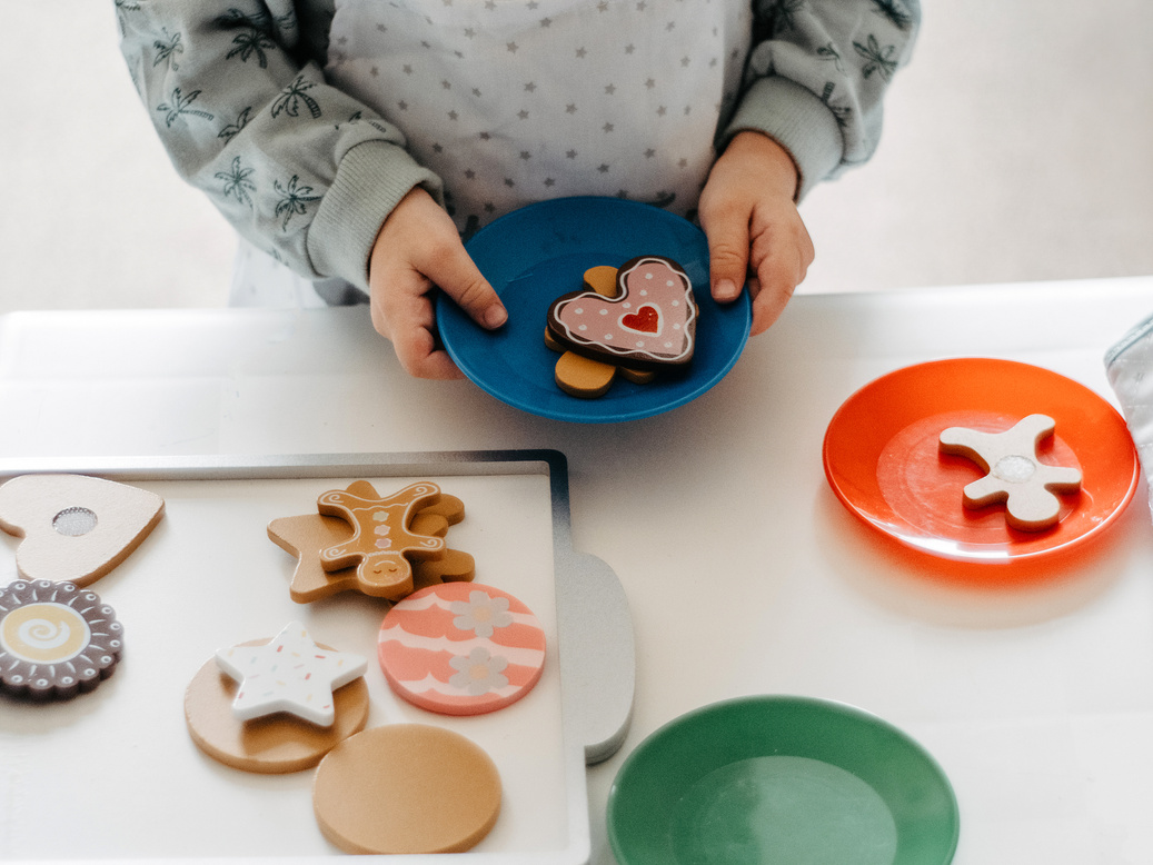 Child Holding Plastic Plate with Toys